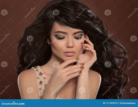 Beauty Hair And Golden Manicure Nails Beautiful Brunette Model Stock
