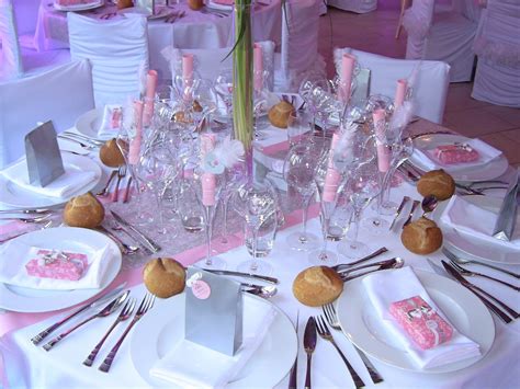 The Table Is Set With White Plates And Silverware Pink Napkins And Flowers