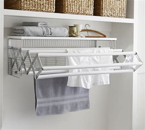 This aluminum collapsible wall drying rack is a useful item to have at home. Wall-Mounted Laundry Drying Rack | Pottery Barn