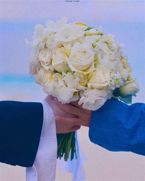 A Person Holding A Bouquet Of White Flowers