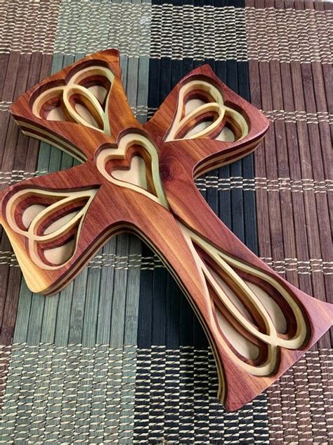 A Wooden Cross Sitting On Top Of A Mat
