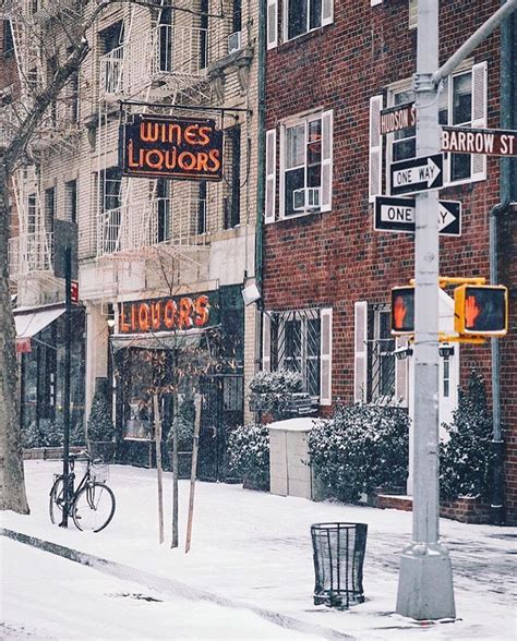 A Snowy Street Corner With Buildings And Signs On Its Sides In The Winter