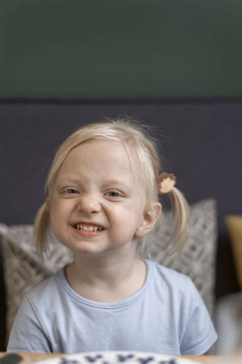 Portrait Of Cute Blonde Girl With Two Tails Three Year Old Girl Smiles At The Camera And