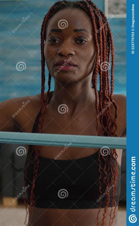 black woman trainer practicing sport stretching body muscle using elastic bands stock image