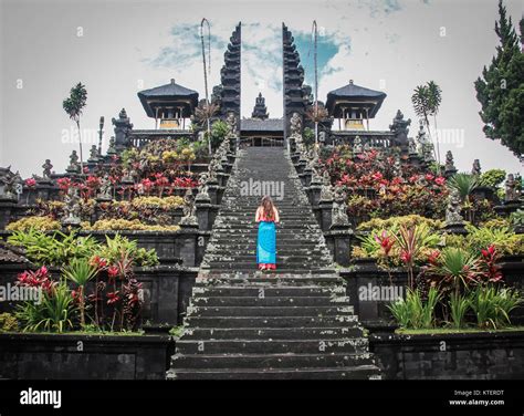 European Female Tourist Poses Backward In Front Of Besakih Temple In