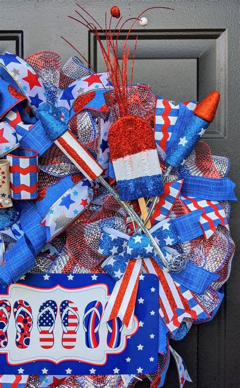 A Patriotic Wreath With Red White And Blue Decorations