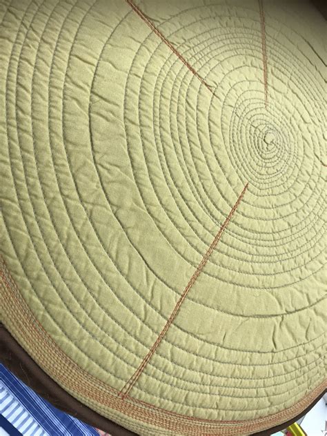 A Close Up View Of A Circular Quilt