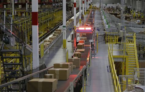 More than half the units sold in our stores are from independent sellers. Packages move on a conveyor belt at Amazon's fulfillment ...