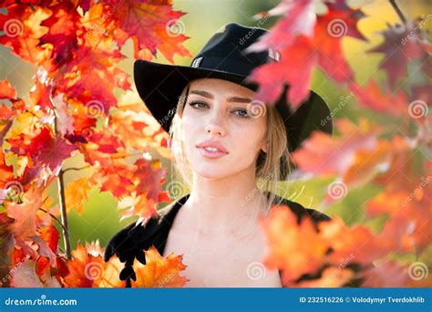 Autumn Woman With Yellow Maple Leaves Closeup Portrait Of A Beautiful Girl In Black Hat Near