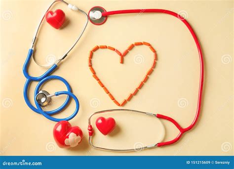 Medical Stethoscopes Pills And Red Hearts On Light Background