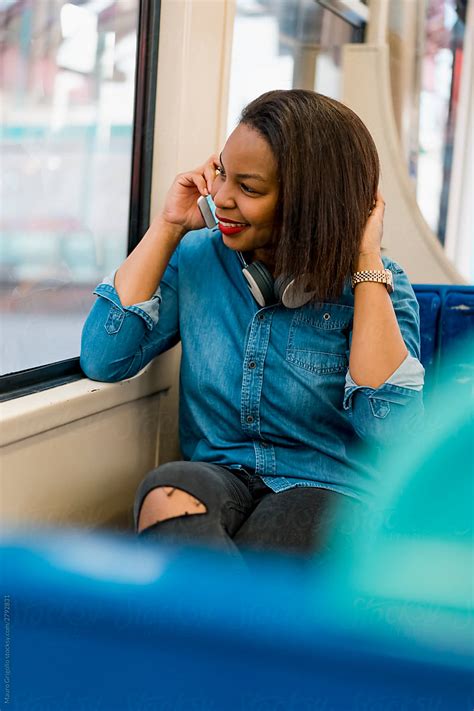 A Woman Having A Phone Call In The Train Del Colaborador De Stocksy