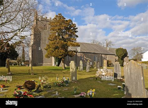 Gravestones And Flowers In Graveyard Of St Cuthberts Church Aldingham