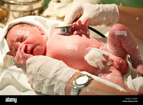 New Born Baby Boy Is Being Examined With A Stethoscope After Birth In