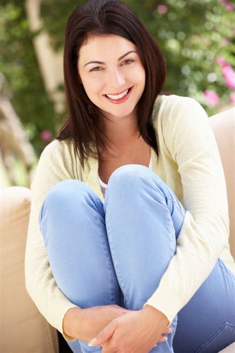 Woman Relaxing On Sofa At Home Stock Photo Image Of Happy Relaxed