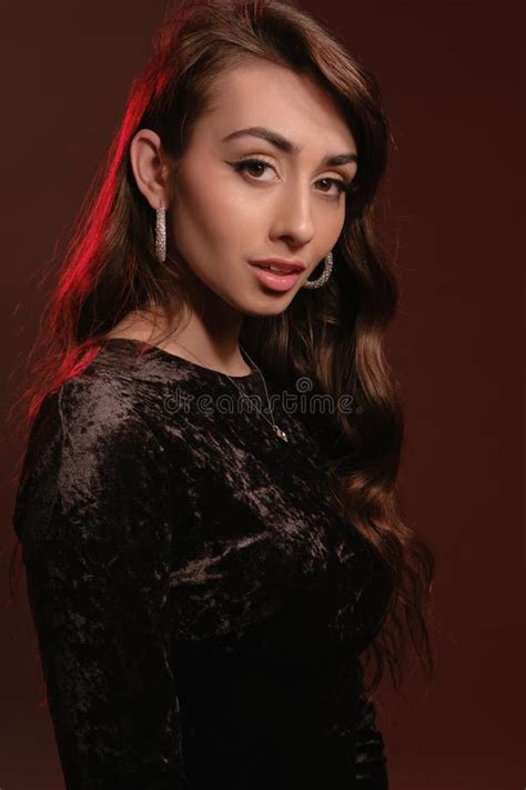 Attractive Brunette Lady In Stylish Jewelry And Black Velvet Dress