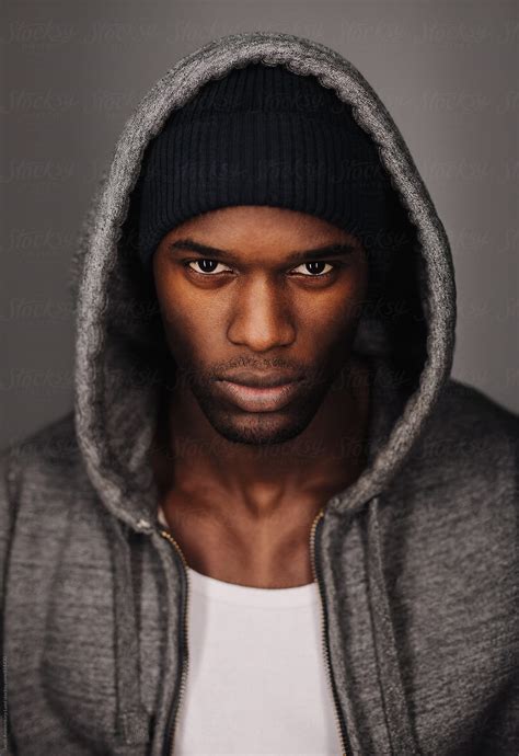 Black Man In Urban Style Looking Tough On Grey Background By Stocksy