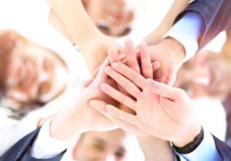 Business People Joining Hands In A Circle In The Office Stock Photo