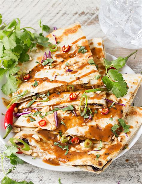 Tortillas stuffed with cheese and whatever else your heart desires, pan fried until the interior is. Thai Peanut Chicken Quesadillas - The Chunky Chef