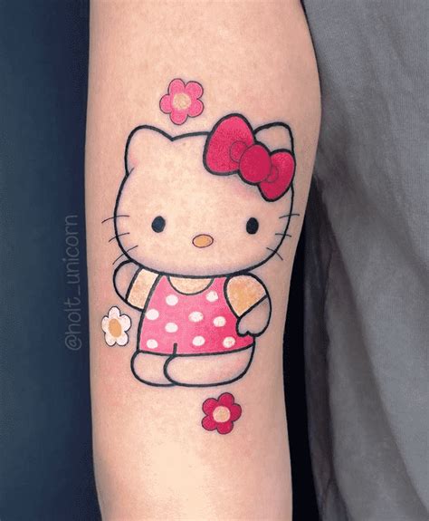 A Hello Kitty Tattoo On The Left Arm With Flowers And Dots Around Her Neck