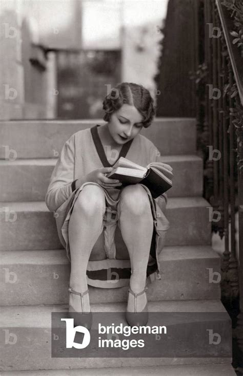 A Young Woman Sitting On A Staircase Reads A Book Her Panties Visible Annees 1920 Germany