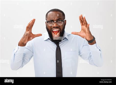 Portrait Of Desperate Annoyed Black Male Screaming In Rage And Anger