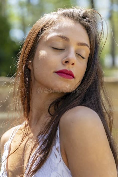 A Lovely Brunette Model Enjoys An Spring Day Outdoors Stock Image