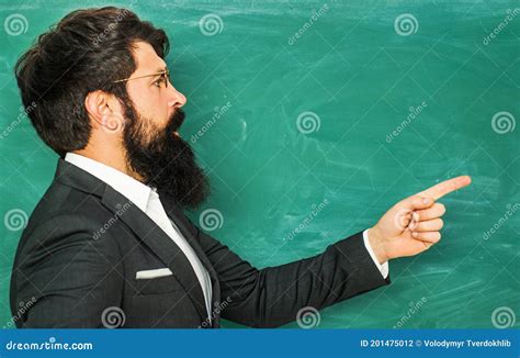 Bearded Professor At School Lesson At Desks In Classroom Education