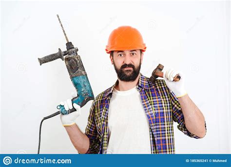 Bearded Builder Working With Hammer And Drill Builder With