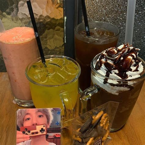 There Are Many Drinks On The Table With Pictures Around Them And One