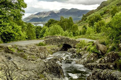 Traditional Stone Bridge Over River In Lake District National Park