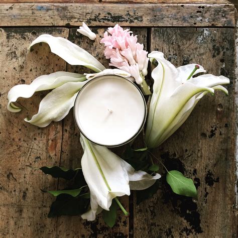 A Candle And Some Flowers On A Wooden Table