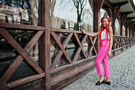 fashionable african american girl at pink pants and red dreads posed outdoor 10575806 stock