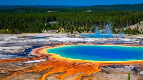yet another yellowstone tourist ignores safety warnings and struts across grand prismatic