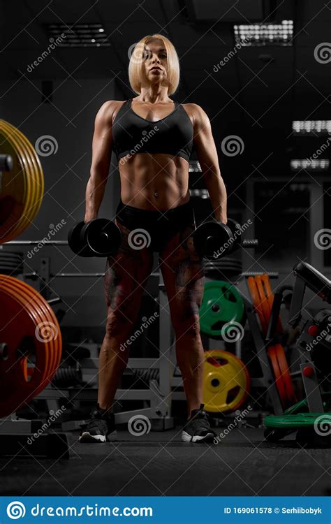 Female Bodybuilder Posing With Dumbbells Stock Photo Image Of Muscle