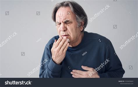 Elderly Man Coughing On Isolated Background Stock Photo 1018429603