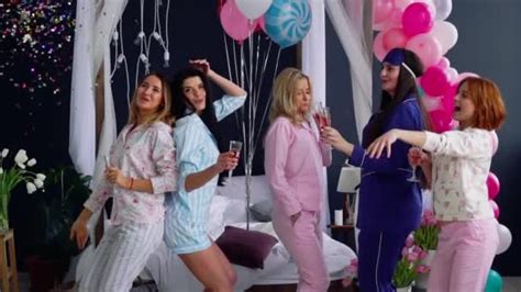 A Group Of Dancing Girls At A Pajama Party With Glasses Of Champagne