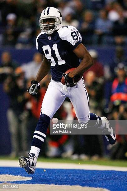 Terrell Owens Of The Dallas Cowboys Carries The Football After Scoring