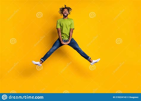 Full Length Photo Portrait Of Guy Jumping Up Spreading Legs Isolated On