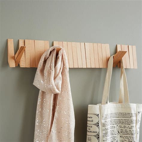 This Stylish Wooden Coat Rack Has Hooks That Pivot Out Only When You