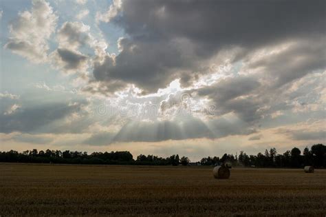 Clouds With Sunbeams On The Background Of The Field After Harvest Stock