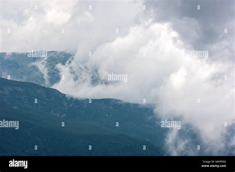Mountains Surrounded By Clouds Close Up Stock Photo Alamy