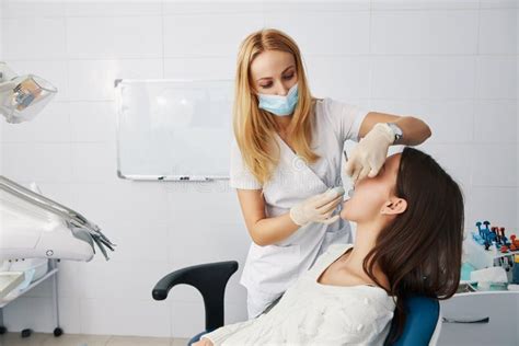 Dentist Putting Putty Stone Into Patient Mouth For Dental Impression