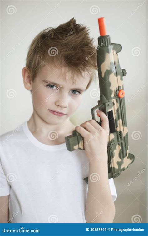 Side View Of A Young Boy Holding Toy Gun Stock Image Image Of Blond