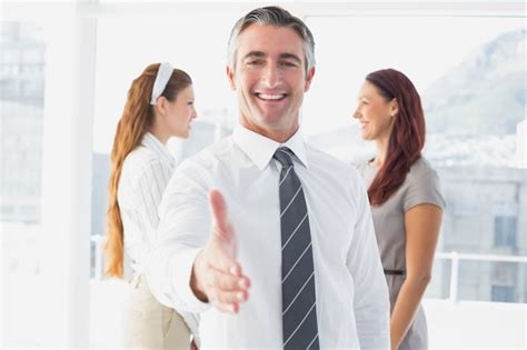Premium Photo Smiling Businessman Offering A Handshake At Work
