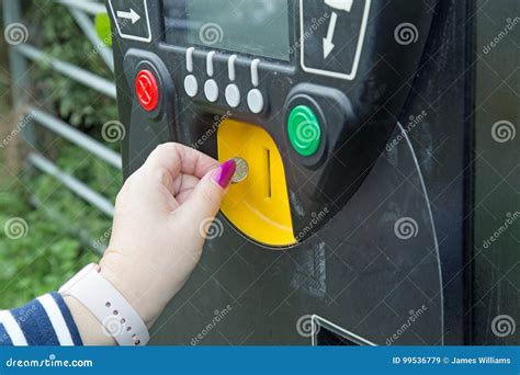 A Female Hand Putting A Coin Into A Parking Meter Stock Image Image