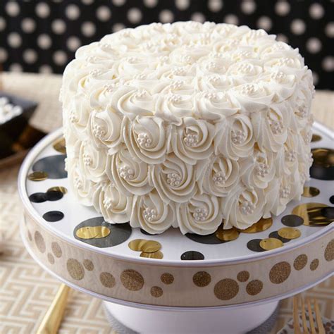12 tomatoes takes on cake decorating! Pure White Rosette Wedding Cake | Wilton