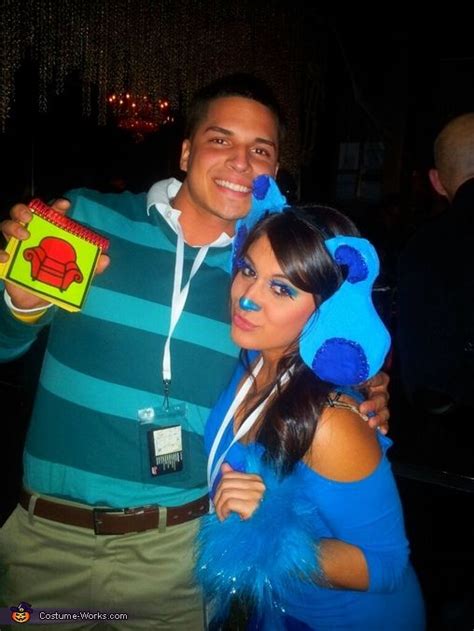 A Man And Woman Posing For A Photo At A Party With Blue Decorations On