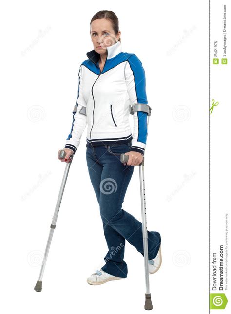 Pensive Looking Woman Using Crutches To Walk Royalty Free