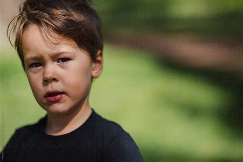 Candid Portrait Of Sad Or Serious Child Outside By Stocksy