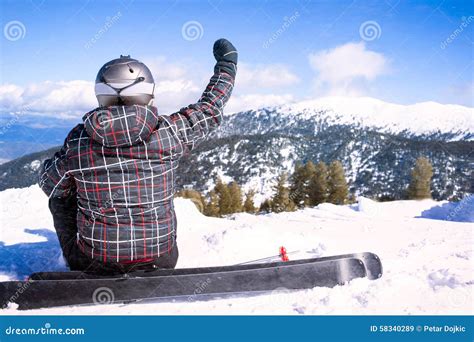 Rear View Of Sportsman With Snowboard Standing On Top Of Mount Stock